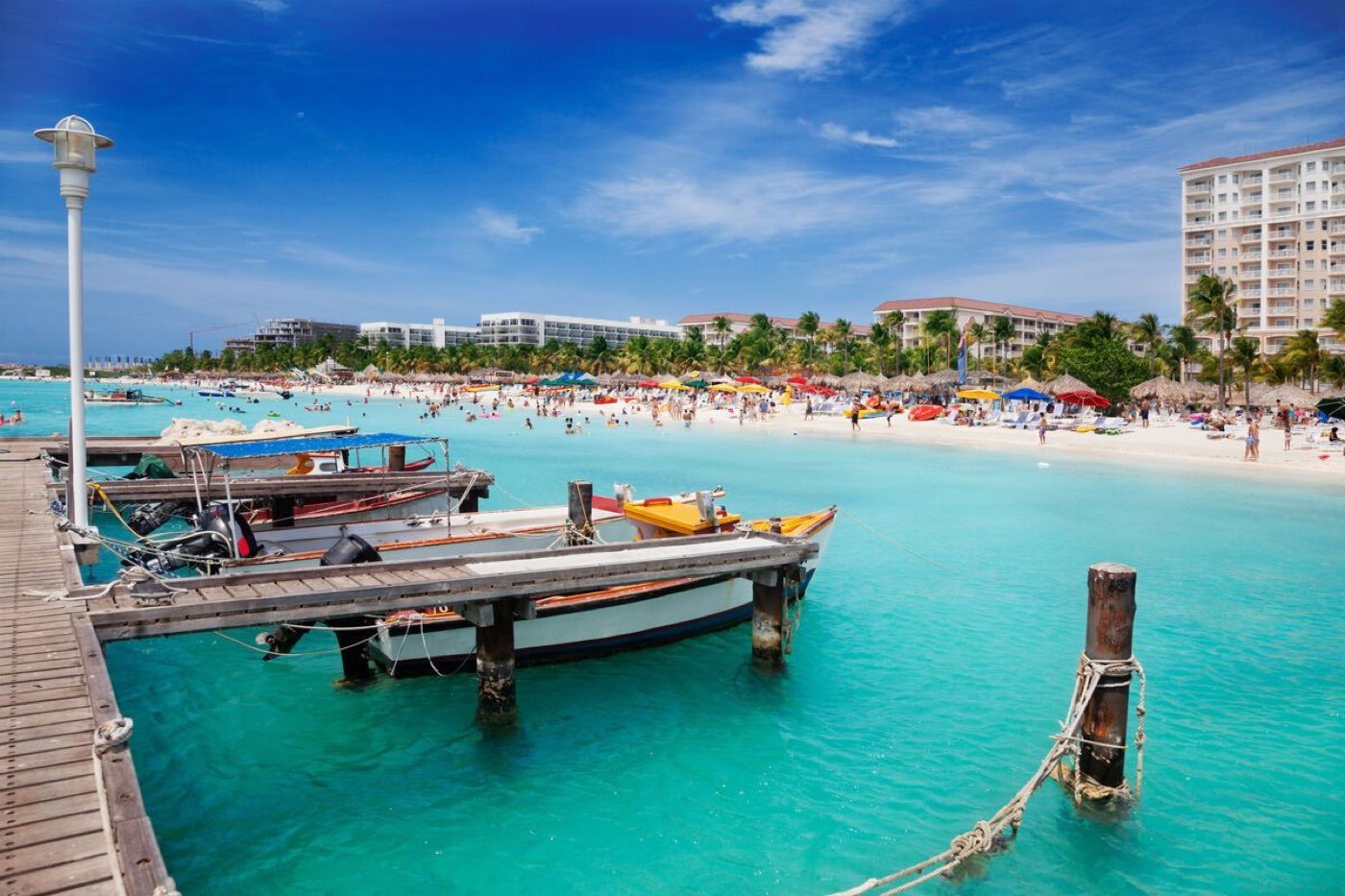 Palm Beach in Aruba with turquoise water and a wooden pier