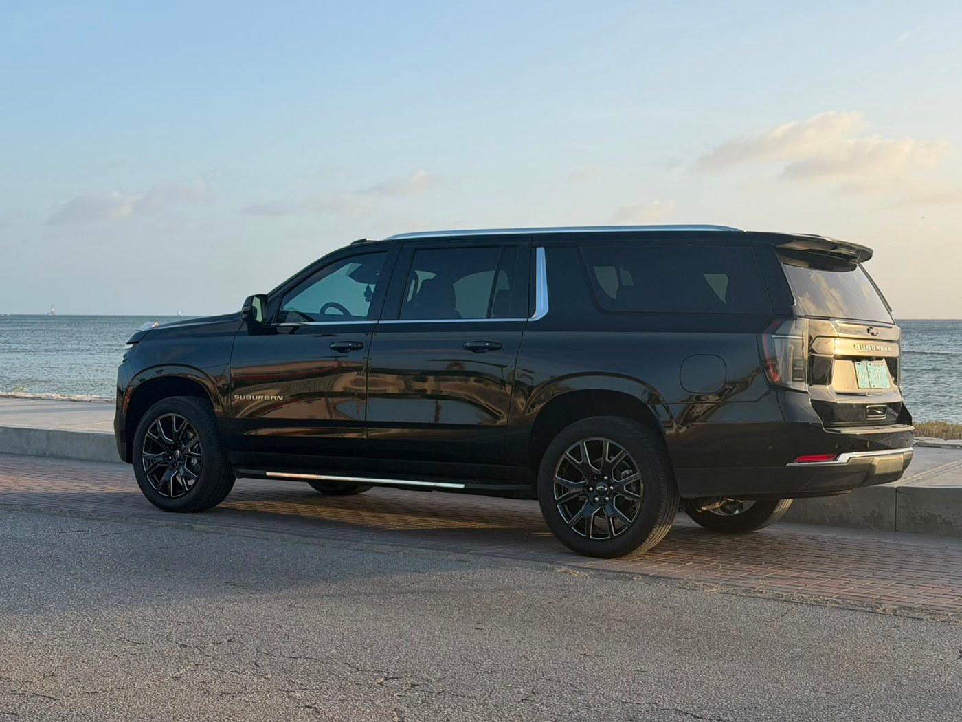 A Dushi Transfers SUV parked on the Aruba coast at sunset